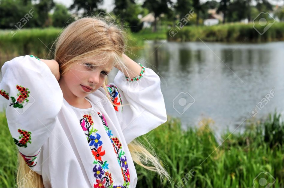 15679834-ukrainian-girl-in-traditional-clothes-against-rural-landscape-background-Stock-Photo.jpg
