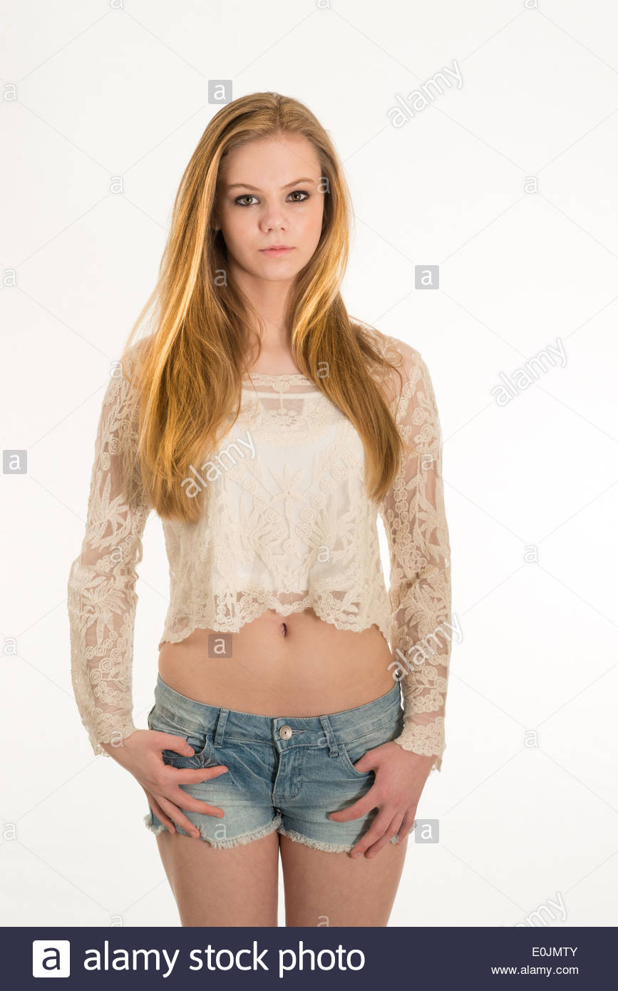teen-girl-portrait-in-shorty-top-and-cut-off-jeans-E0JMTY.jpg