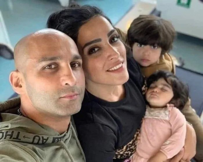 Boxer-Ahmad-Shirazi-and-his-wife-take-a-family-photo-where-his-wife-didnt-have-hijab-In-response-the-Iranian-regime-sentenced-them-both-to-16-years-in-prison-and-74-lashes-for-spreading-debauchery-and-prostitution.jpg