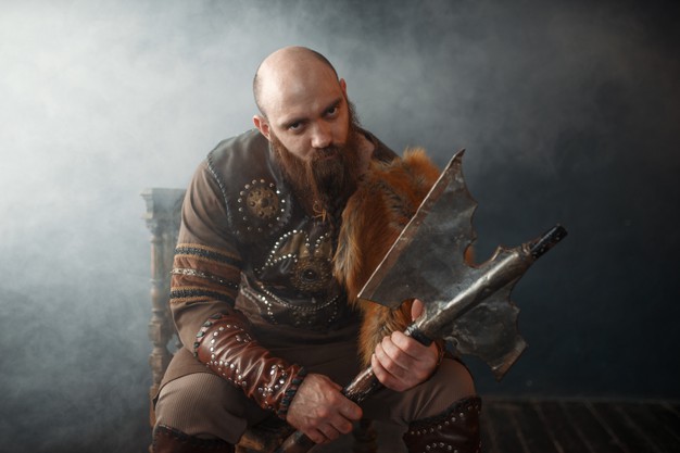 bearded-viking-with-axe-sitting-on-chair_266732-9815.jpg
